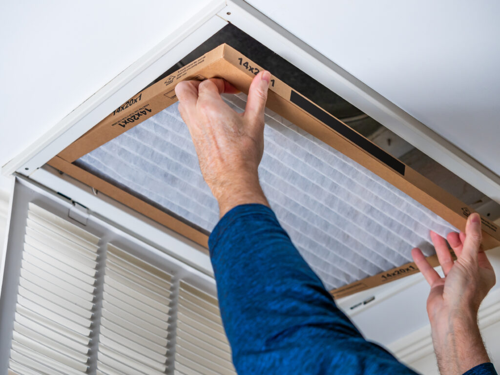 HVAC technician replacing a home air filter in Campbell