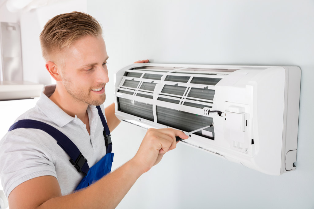 HVAC technician maintaining a ductless air conditioner in Campbell