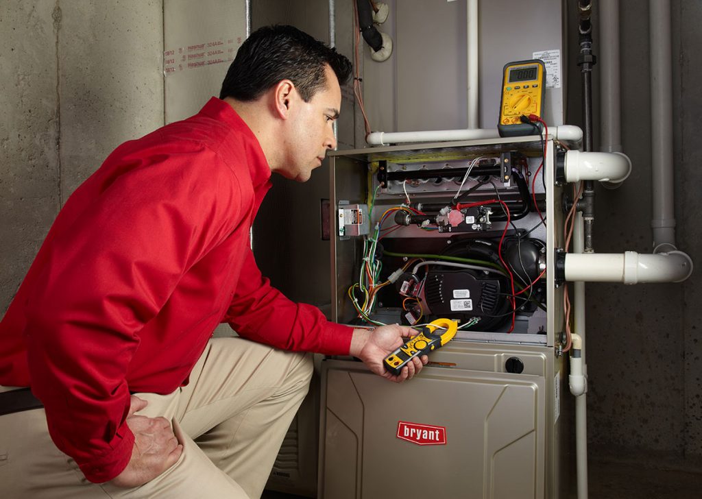 Heating technician diagnosing a furnace repair in Campbell