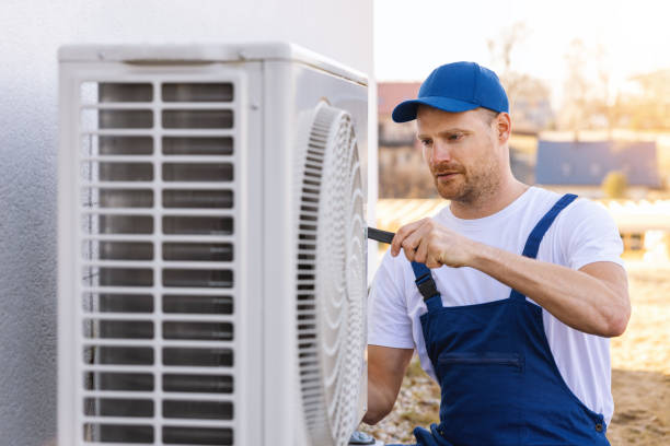 HVAC technician servicing an outdoor air conditioner in Campbell