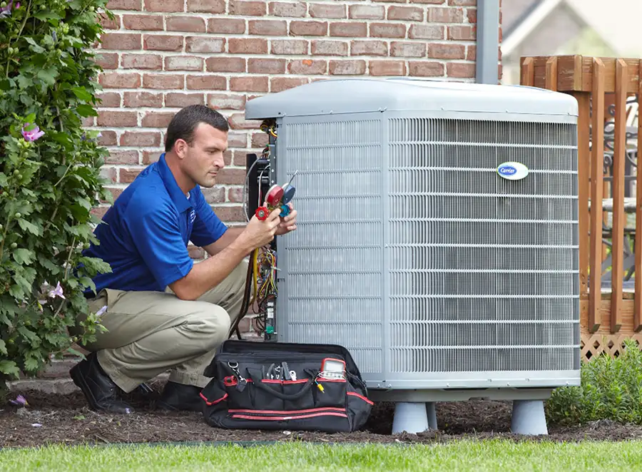 HVAC technician inspecting an outdoor AC unit in Campbell